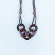 Collana con cerchi in legno e perle in ceramica vetrificata viola e rosa antico COD: 21129510000